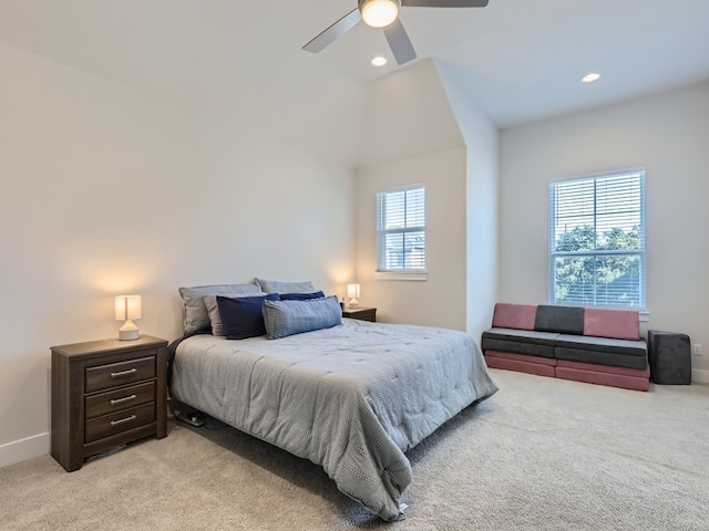 carpeted bedroom featuring ceiling fan and vaulted ceiling