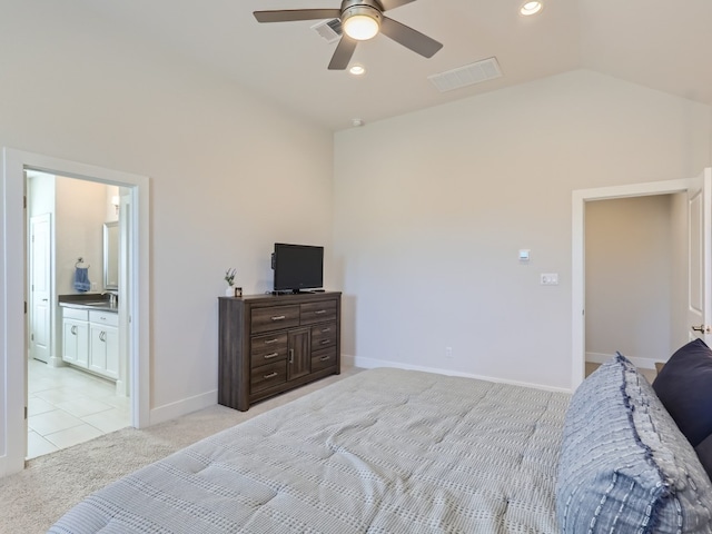 bedroom with light carpet, ensuite bath, ceiling fan, lofted ceiling, and sink