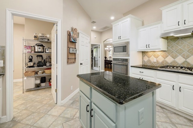 kitchen with a center island, appliances with stainless steel finishes, and white cabinetry