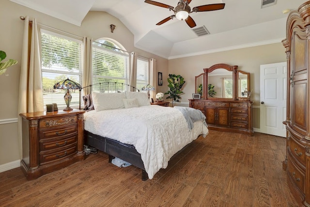 bedroom with ornamental molding, ceiling fan, vaulted ceiling, and dark wood-type flooring