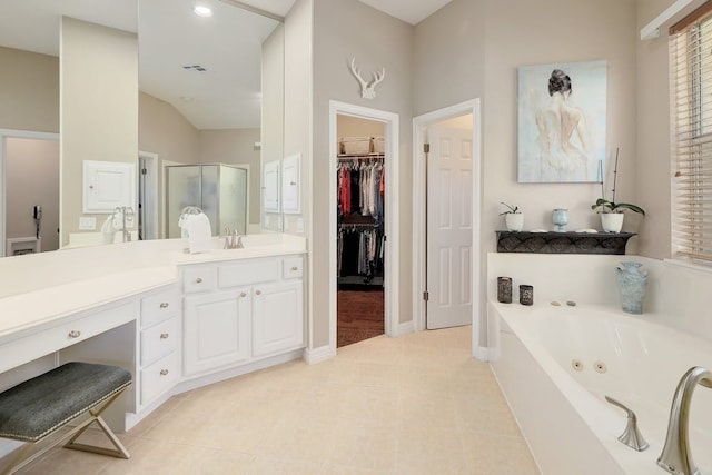 bathroom with vanity, shower with separate bathtub, tile floors, and lofted ceiling