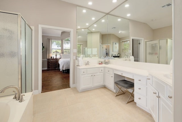 bathroom featuring separate shower and tub, hardwood / wood-style floors, vanity, and vaulted ceiling