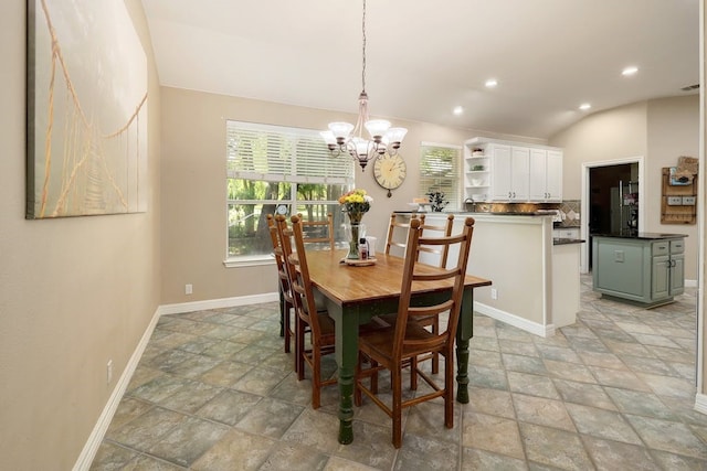 tiled dining area featuring lofted ceiling and a chandelier