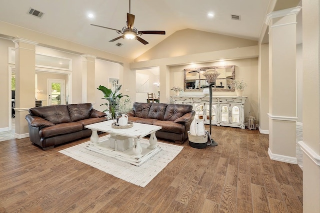 living room with decorative columns, high vaulted ceiling, ceiling fan, and dark hardwood / wood-style flooring