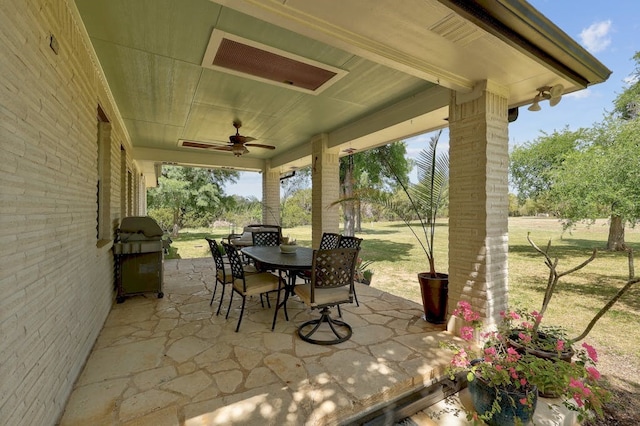 view of patio with ceiling fan and area for grilling