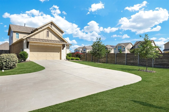 view of front of house featuring a front lawn and a garage