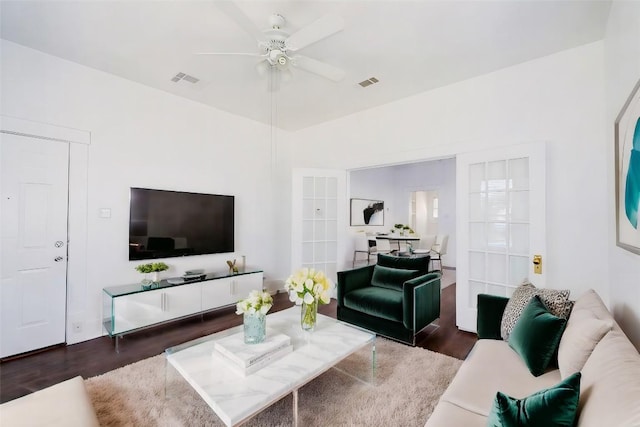 living room with french doors, dark hardwood / wood-style floors, and ceiling fan