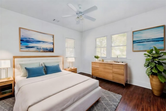 bedroom with ceiling fan and dark hardwood / wood-style floors