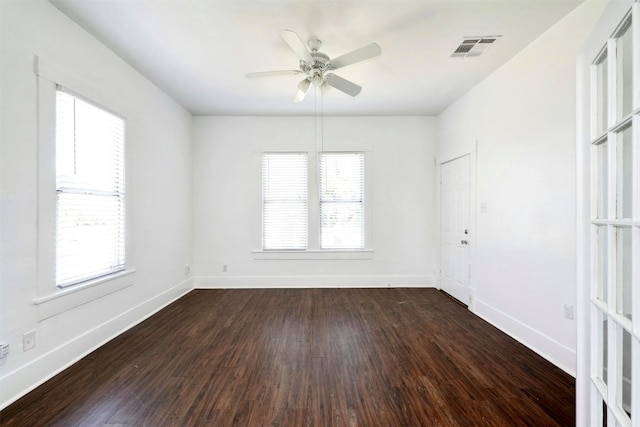 empty room with ceiling fan and dark hardwood / wood-style floors