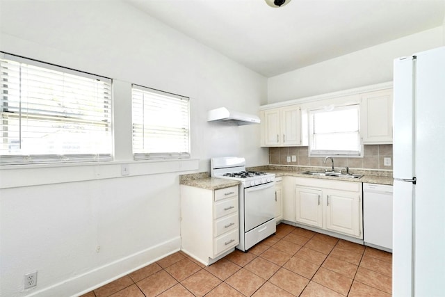 kitchen with white cabinetry, sink, tasteful backsplash, range hood, and white appliances