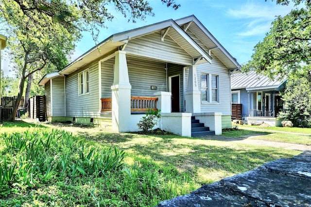 view of front of property with covered porch and a front yard