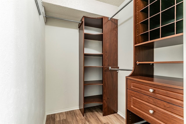 spacious closet with light hardwood / wood-style floors