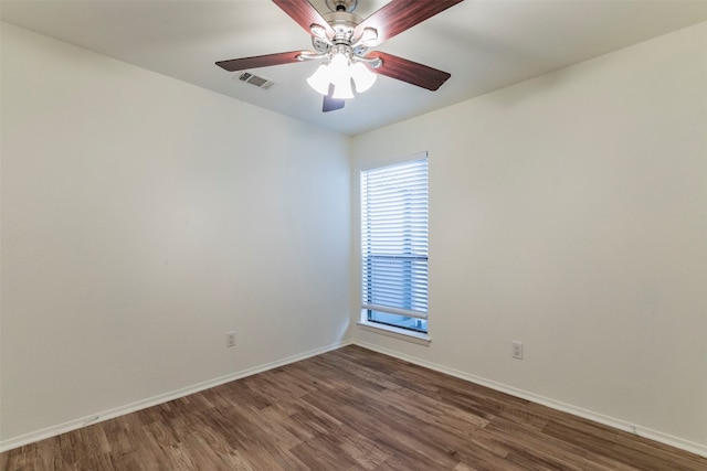 spare room with ceiling fan and dark wood-type flooring