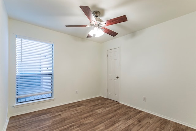 empty room featuring ceiling fan and dark hardwood / wood-style flooring