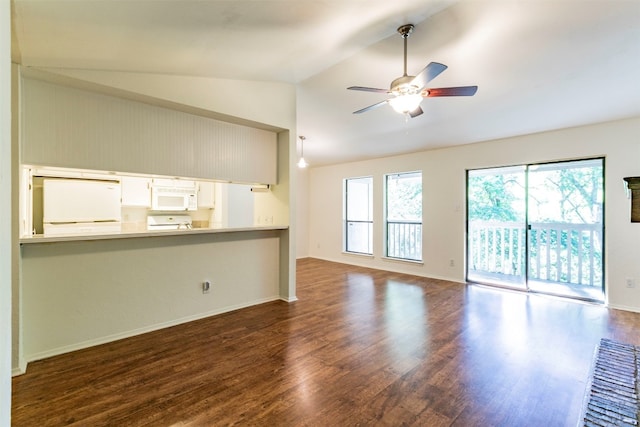 unfurnished living room featuring dark hardwood / wood-style floors, a wealth of natural light, and vaulted ceiling