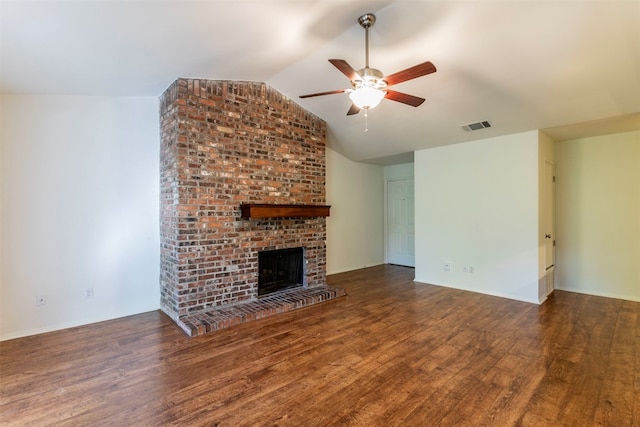 unfurnished living room featuring dark hardwood / wood-style flooring, a fireplace, lofted ceiling, and ceiling fan