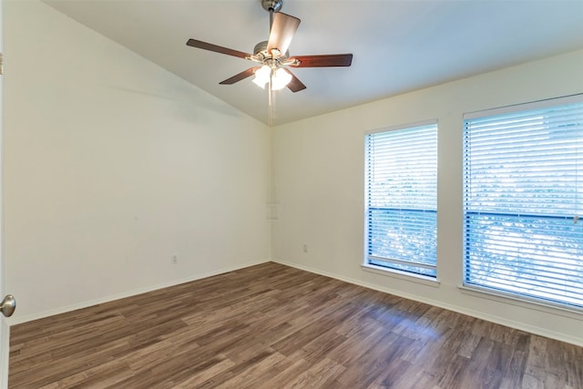 spare room featuring a healthy amount of sunlight, ceiling fan, and dark hardwood / wood-style flooring