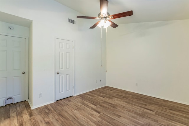 unfurnished bedroom with ceiling fan, wood-type flooring, and vaulted ceiling