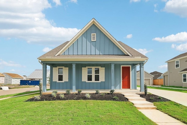 view of front of house with covered porch and a front lawn