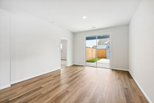 unfurnished room with light hardwood / wood-style floors