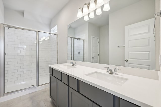 bathroom with tile patterned flooring, vanity, and an enclosed shower