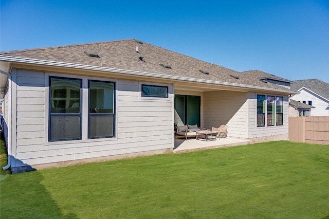 back of house featuring an outdoor hangout area, a patio, and a lawn