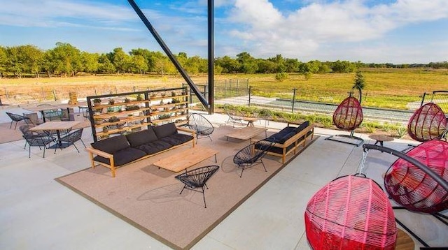 view of patio / terrace with an outdoor living space and a rural view