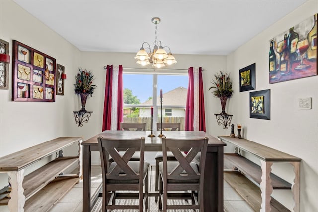 dining space with light tile patterned floors and an inviting chandelier