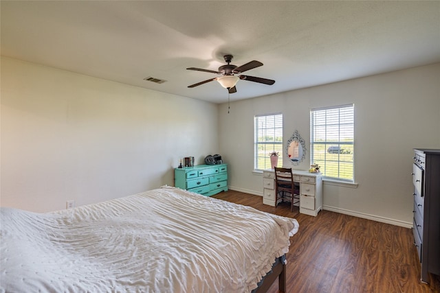 bedroom with ceiling fan and dark wood-type flooring