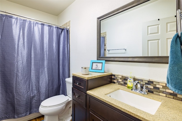 bathroom with backsplash, vanity, a shower with shower curtain, and toilet