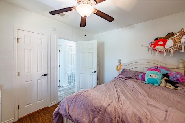 bedroom with ceiling fan and dark hardwood / wood-style floors