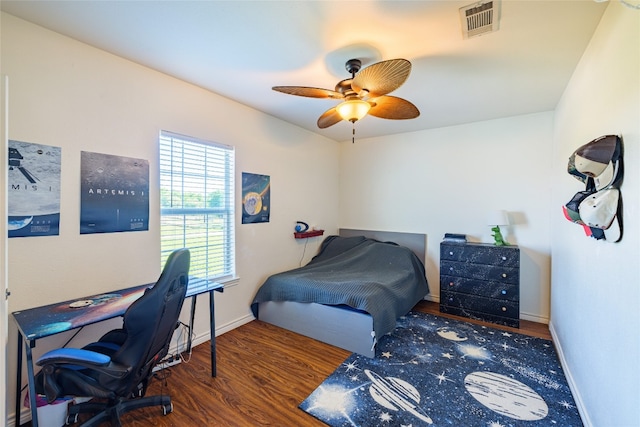 bedroom featuring ceiling fan and dark wood-type flooring