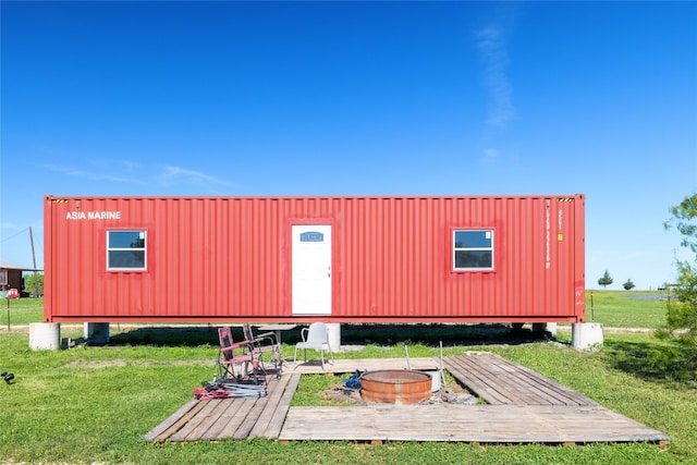 view of outbuilding with a lawn