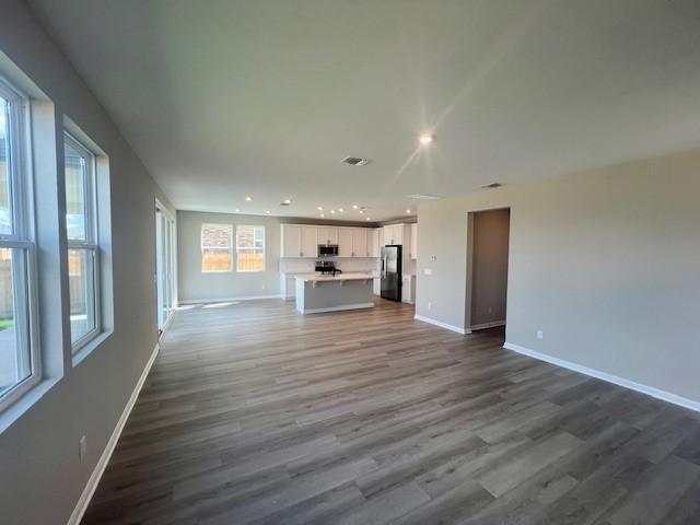 unfurnished living room with wood-type flooring