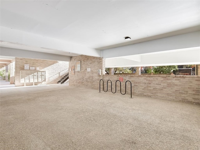 interior space with carpet floors and brick wall