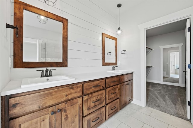 bathroom with tile floors, oversized vanity, and double sink