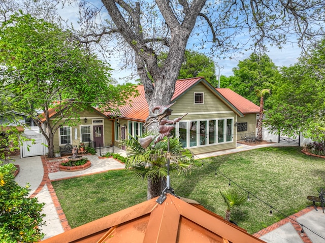 rear view of property featuring a yard