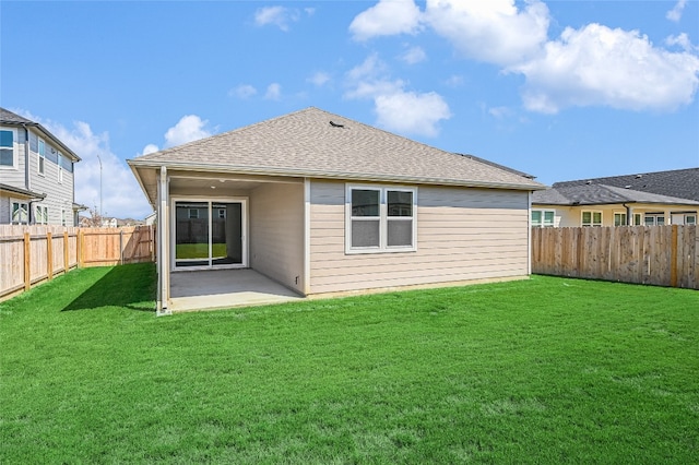 rear view of house with a lawn and a patio area