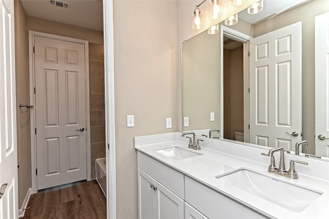 full bathroom featuring shower with separate bathtub, wood-type flooring, vanity, and toilet