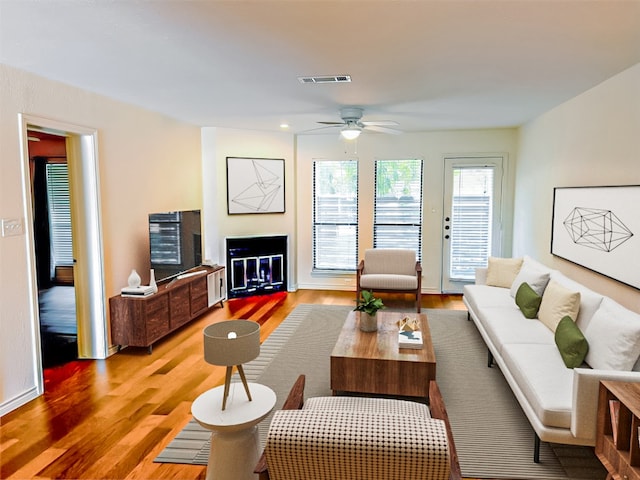 living room with hardwood / wood-style flooring and ceiling fan