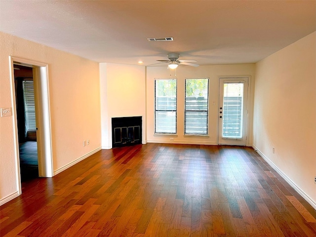 unfurnished living room with ceiling fan and dark hardwood / wood-style flooring