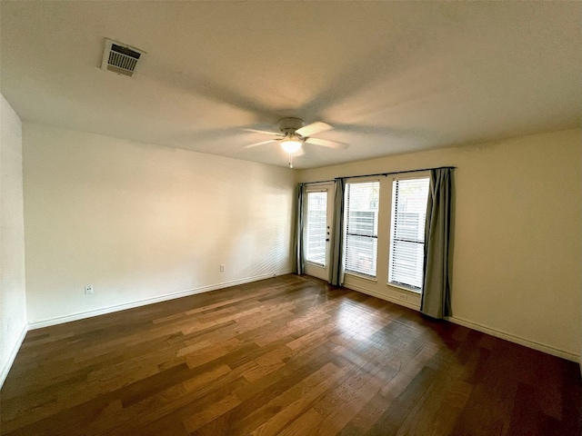 spare room with ceiling fan and dark hardwood / wood-style flooring