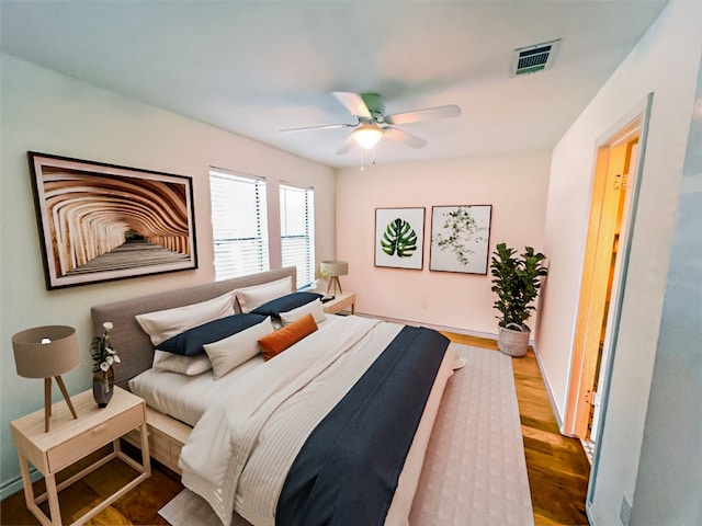 bedroom with ceiling fan and hardwood / wood-style floors