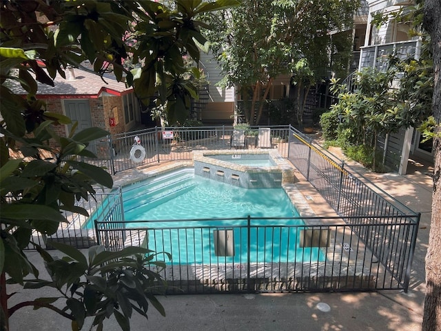 view of pool with a patio and a community hot tub