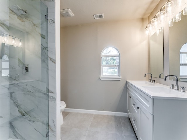 bathroom with toilet, a shower with shower door, vanity with extensive cabinet space, a textured ceiling, and tile floors