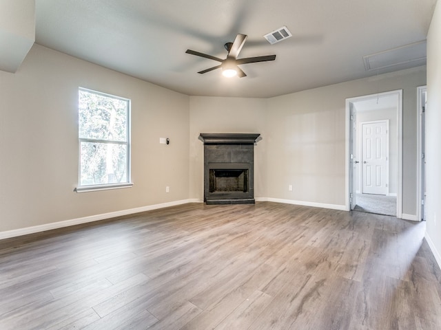 unfurnished living room featuring ceiling fan and light wood-type flooring