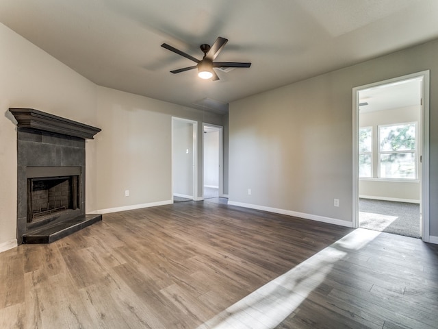 unfurnished living room with dark carpet and ceiling fan