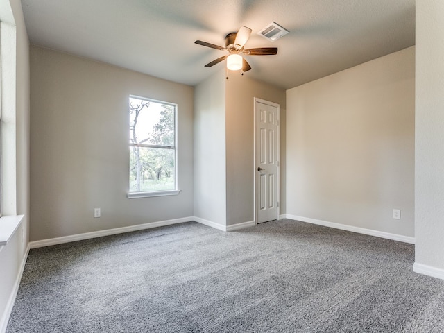 carpeted spare room with ceiling fan