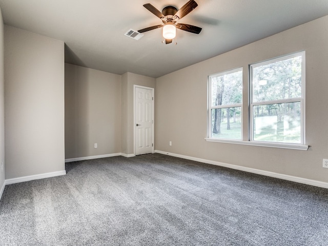 carpeted empty room featuring ceiling fan