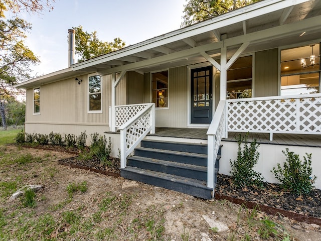 view of exterior entry with a porch